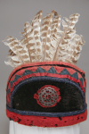 A photograph of the front of the hat with brooch and bird feathers visible.