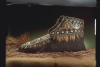 A photograph of the side of the moccasin against a dark backdrop.