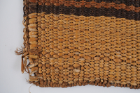 Detail of the corner edge of the mat, where the weaving is loose.